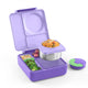 Purple bento box with compartments containing food on a white background