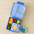 Blue bento box with compartments filled with fruits, vegetables, and macaroni and cheese on a beige surface.