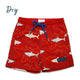 Red swim shorts with shark pattern on a white background